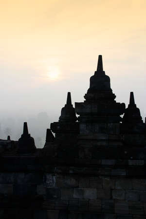 Silhouette Borobudur Temple with the mysteries forest surrounding at dawn, Yogyakarta, Indonesiaの写真素材