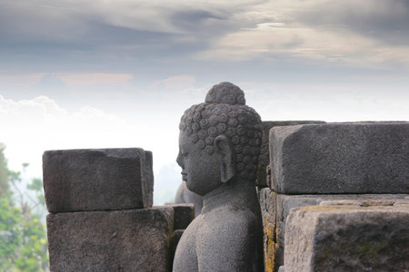Borobudur Temple with the Buddha Head and mysteries forest surrounding during sunrise, Yogyakarta,...