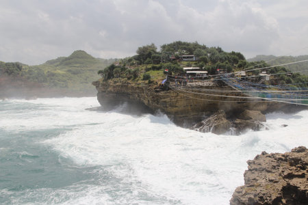 Timang beach with big wave surrounding in sunny day, Yogyakarta, Indonesia