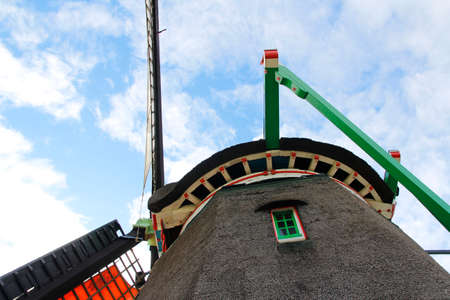 Closeup of a traditional Dutch Windmill in a sunny day at the Zaanse Schans, Zaandam, Netherlandsの写真素材