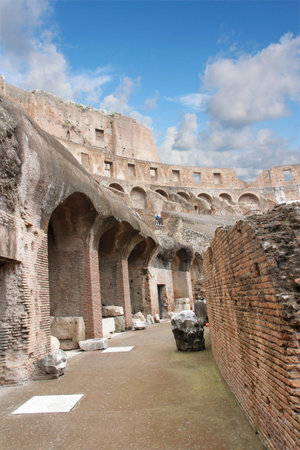 Interior of the Colosseum or Coliseum with the bricks wall and arches in Rome, Italy