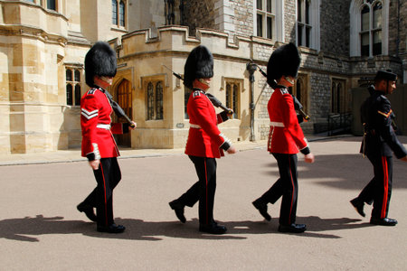 The Guards march up the High Street and into the Windsor Castle on a sunny day