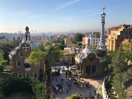 View of the Dragon Stairway and terrace with tourists in Park Guell, Barcelona, Spain