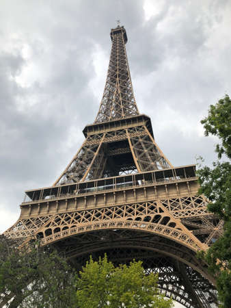 An Eiffel Tower view with the branches in cloudy day, Paris, Franceの写真素材