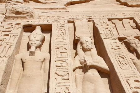 Colossal standing statues of Ramses and Nefertari at entrance of the Temple of Nefertari, Egypt
