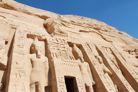 Colossal standing statues of Ramses and Nefertari at entrance of the Temple of Nefertari, Egypt