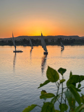 Felucca sailing on Nile River during sunset at Aswan, Egypt