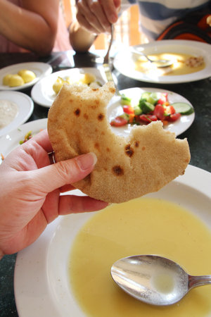 Egyptian flatbread Aish Baladi served with Tahini soup in a Luxor restaurant, Egyptの写真素材