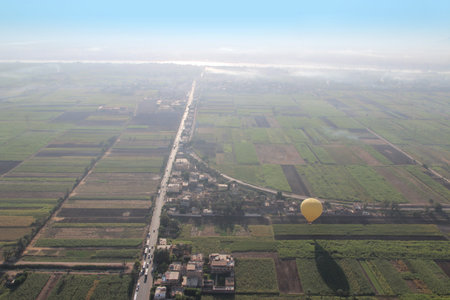 Crops on East bank of Luxor with a hot air balloon in the morning, Egyptの写真素材