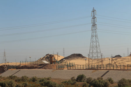 Scenery view of Aswan with transmission towers and desert along the road in sunny day, Egyptの写真素材