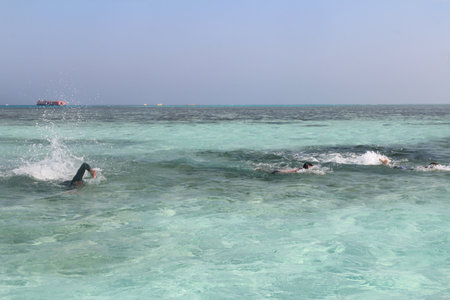 Red sea seascape with tourists swimming on a sunny day in Hurghada, Egyptの写真素材