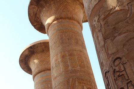 Columns in the form of papyrus stalks with bas-relief at the Great Hypostyle Hall of Karnak Temple...