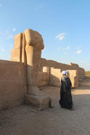 Luxor, Egypt-October 22, 2023: An Egyptian and headless colossal statue at the Easten Edge of Karnak...