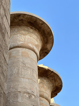 Columns in the form of papyrus stalks with bas-relief at the Great Hypostyle Hall of Karnak Temple...