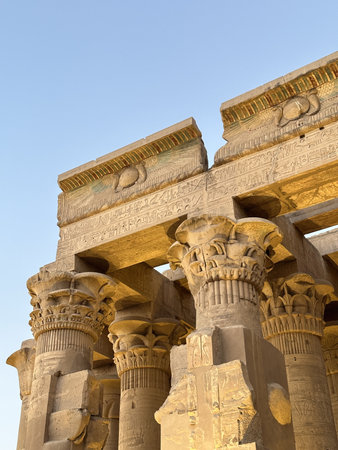 Open bud papyrus column carved with detailed reliefs at the entrance of Kom Ombo Temple, Egyptの写真素材
