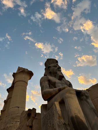 Colossus of seated Ramesses II at Temple of Luxor during sunset, Egypt