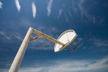 old basketball ring against blue sky