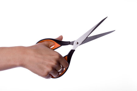 Scissors in hand isolated on white backgroundの写真素材