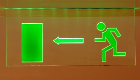 Symbol of emergency exit on the wall