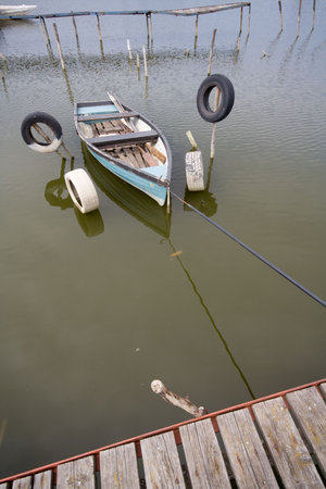 lake with boat and wooden pierの写真素材