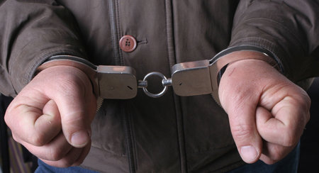 handcuffs in hand