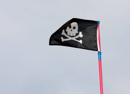 black pirate flag with death's head の写真素材