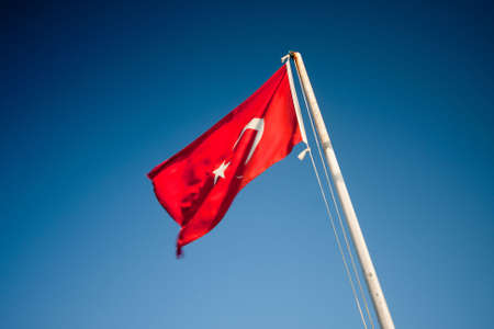 Turkish flag over blue sky の写真素材