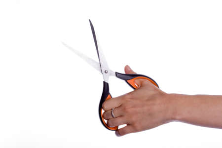 Scissors in hand isolated on white backgroundの写真素材