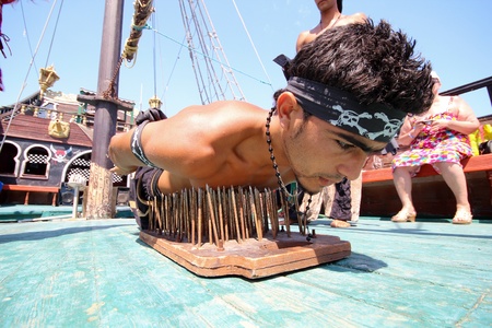 SOUSSE, TUNISIA - AUG 01: Young Fakir participates in fakir show in a pirate boat on Aug 01, 2011 in Sousse, Tunisiaのeditorial素材