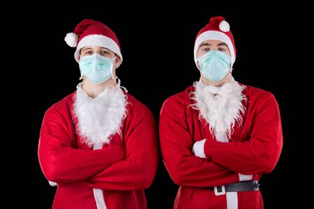 Two santa claus wearing maskの写真素材