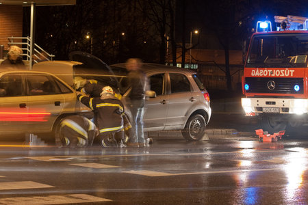 PECS, HUNGARY - DEC. 01: car crashed. Firefighter try to help the victim of car accident on Dec. 01,...