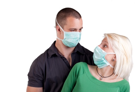 young people wearing flu masks over whiteの写真素材