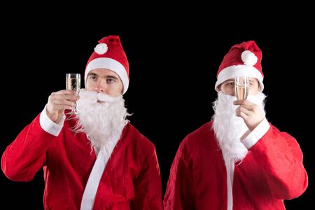 Two santa claus with champagneの写真素材