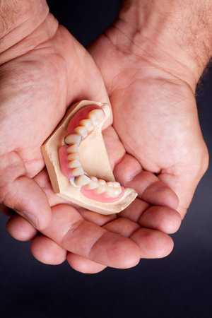 detail dental wax model in human palm