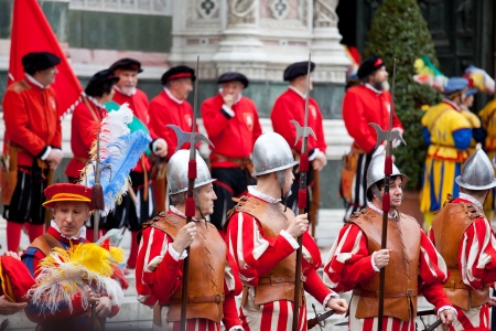 FLORENCE, ITALY - EASTER SUNDAY MARCH 31, 2013: Flag bearers walk in Easter parade wearing historical costumes on March 31, 2006, Florence, Italy. Celebration のeditorial素材