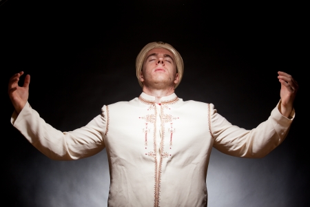 Young man in oriental costume and turbanの写真素材
