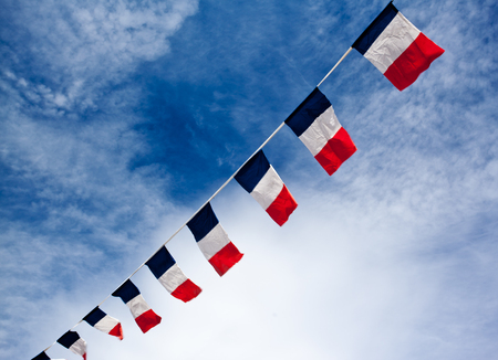 French flags blowing in the windの写真素材