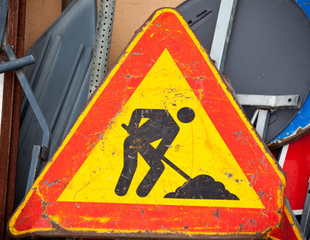 old under construction road sign