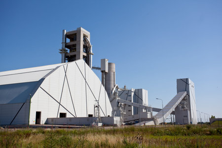 Cement factory machinery on a clear blue dayのeditorial素材