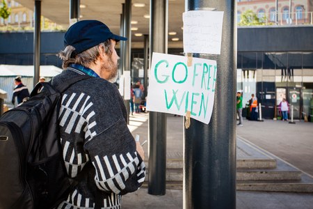 BUDAPEST - SEPTEMBER 7: war refugees reading go Wien text at Keleti Railway Station on 7 September 2015 in Budapest, Hungary. Refugees are arriving constantly to Hungary on the way to Germany.のeditorial素材