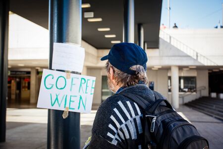 BUDAPEST - SEPTEMBER 7: war refugees reading go Wien text at Keleti Railway Station on 7 September 2015 in Budapest, Hungary. Refugees are arriving constantly to Hungary on the way to Germany.のeditorial素材