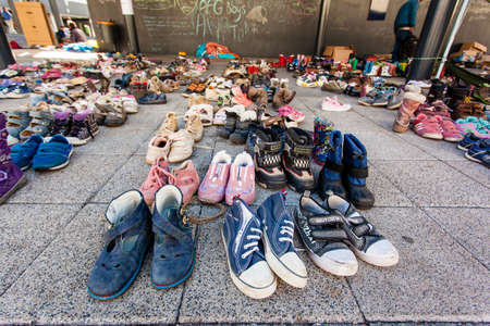 BUDAPEST - SEPTEMBER 7: child shoes for war refugees at Keleti Railway Station on 7 September 2015 in Budapest, Hungary. Refugees are arriving constantly to Hungary on the way to Germany.のeditorial素材