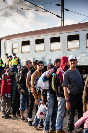 GYEKENYES- OCTOBER 5 : War refugees at the Gyekenyes Zakany Railway Station on 5 October 2015 in Gyekenyes, Hungary. Refugees are arriving constantly to Hungary on the way to Germany.のeditorial素材