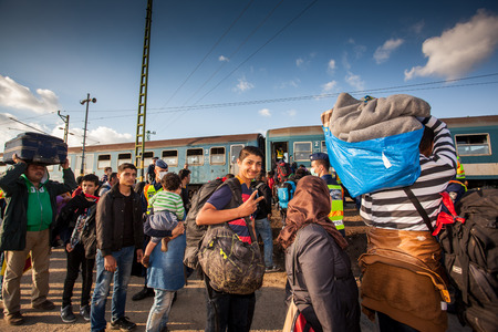 GYEKENYES- OCTOBER 5 : War refugees at the Gyekenyes Zakany Railway Station on 5 October 2015 in Gyekenyes, Hungary. Refugees are arriving constantly to Hungary on the way to Germany.のeditorial素材
