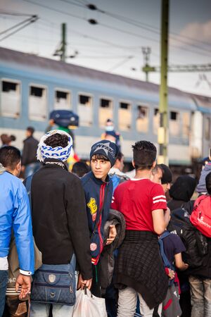 GYEKENYES- OCTOBER 5 : War refugees at the Gyekenyes Zakany Railway Station on 5 October 2015 in Gyekenyes, Hungary. Refugees are arriving constantly to Hungary on the way to Germany.のeditorial素材