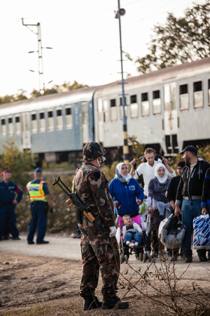 GYEKENYES- OCTOBER 5 : War refugees at the Gyekenyes Zakany Railway Station on 5 October 2015 in Gyekenyes, Hungary. Refugees are arriving constantly to Hungary on the way to Germany.のeditorial素材