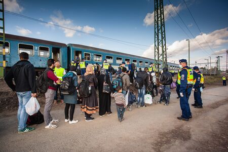 GYEKENYES- OCTOBER 5 : War refugees at the Gyekenyes Zakany Railway Station on 5 October 2015 in Gyekenyes, Hungary. Refugees are arriving constantly to Hungary on the way to Germany.のeditorial素材