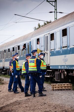 GYEKENYES- OCTOBER 6 : War refugees at the Gyekenyes Zakany Railway Station on 6 October 2015 in Gyekenyes, Hungary. Refugees are arriving constantly to Hungary on the way to Germany.のeditorial素材