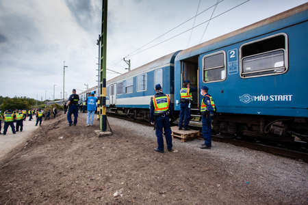 GYEKENYES- OCTOBER 6 : War refugees at the Gyekenyes Zakany Railway Station on 6 October 2015 in Gyekenyes, Hungary. Refugees are arriving constantly to Hungary on the way to Germany.のeditorial素材