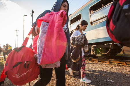 GYEKENYES- OCTOBER 5 : War refugees at the Gyekenyes Zakany Railway Station on 5 October 2015 in Gyekenyes, Hungary. Refugees are arriving constantly to Hungary on the way to Germany.のeditorial素材